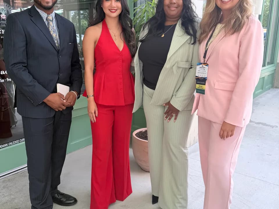 GA Jersey Village team members in business attire outside an event venue
